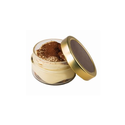 Open glass jar of tiramisu dessert topped with cocoa powder, with its gold lid resting against the side, on a white b...