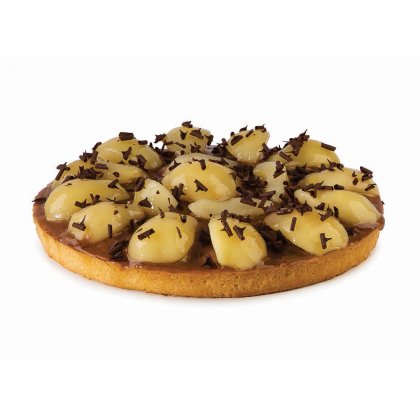 Round tart with caramelized crust, glazed pear slices arranged on top, and chocolate shavings sprinkled over it.