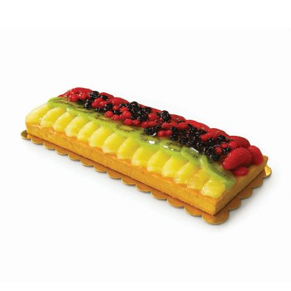 Rectangular fruit tart topped with sliced mango and kiwi, glazed berries, and strawberries on a gold cardboard base.