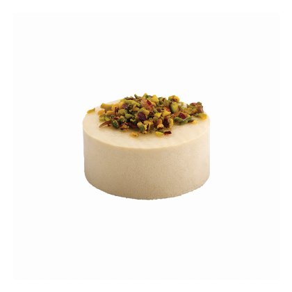 Round cream-colored cake topped with chopped pistachios and dried fruit pieces, on a white background.
