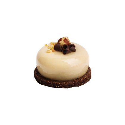 Round mini cake with glossy caramel glaze on a chocolate cookie base, topped with chopped nuts, a whole hazelnut, and...
