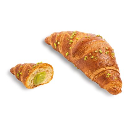 Golden croissant topped with crushed pistachios, one half showing a creamy green pistachio filling.