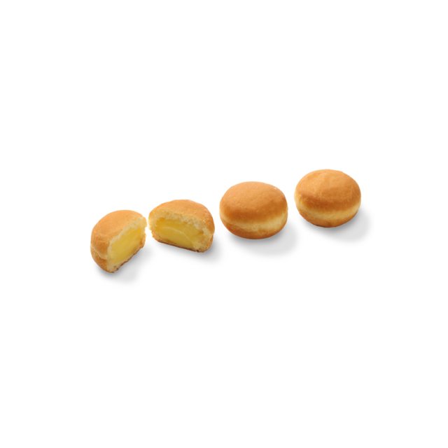 Four round cream-filled donuts on a white background, with one cut open showing yellow custard filling.