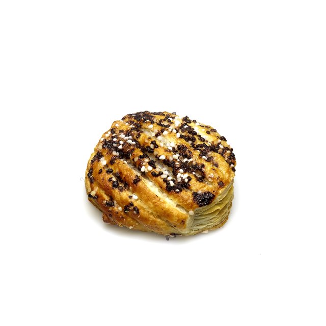 Round golden pastry topped with chocolate chunks, sesame seeds, and pearl sugar, on a white background.