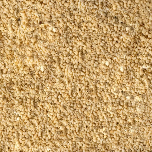 Close-up of fine, granular pale yellow powder with a coarse, crumbly texture covering the entire frame.