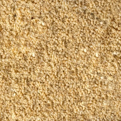 Close-up of fine, granular pale yellow powder with a coarse, crumbly texture covering the entire frame.