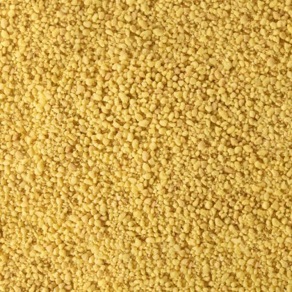 Close-up of fine yellow granular texture, resembling coarse cornmeal or dried couscous grains covering the entire frame.