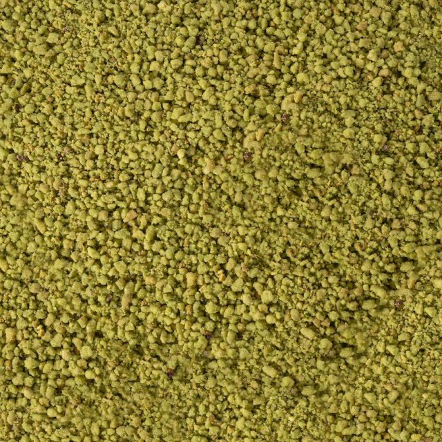 Close-up of a coarse, granular yellow-green powder texture covering the entire frame.