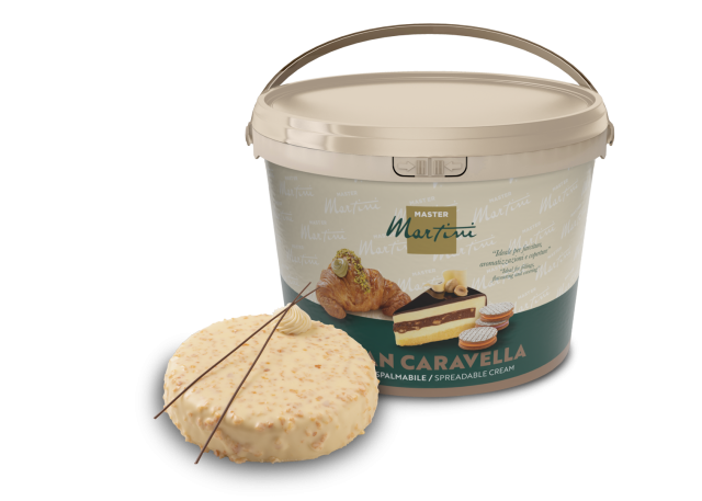 A large plastic bucket of Master Martini Gran Caravella spreadable cream beside a frosted cake slice with pastry deco...