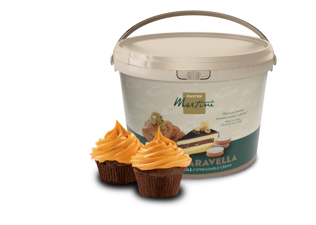 Beige bucket of Master Martini spreadable cream with two chocolate cupcakes topped with orange frosting in front.
