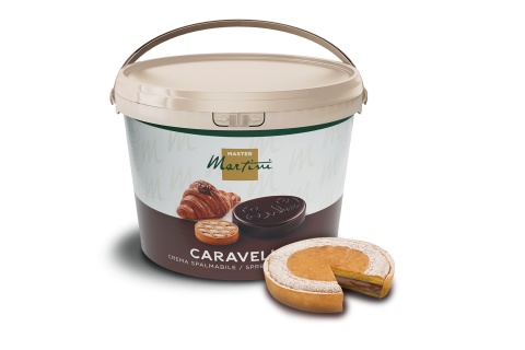 A large bucket of Master Martini Caravella spreadable cream, labeled with croissant and cookie images, beside a slice...