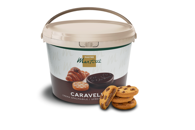 A bucket of Master Martini Caravella chocolate spread beside stacked chocolate chip cookies.