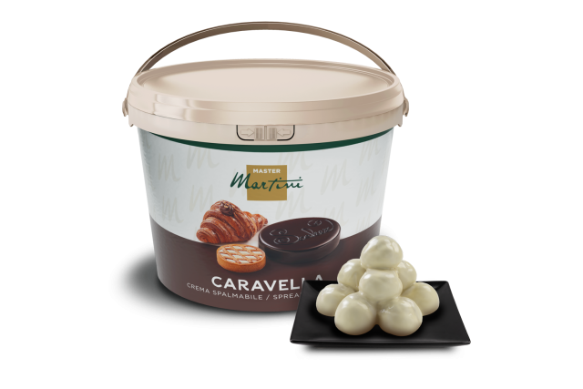 A large tub of Master Martini Caravella spreadable cream beside white chocolate truffles on a black square plate.