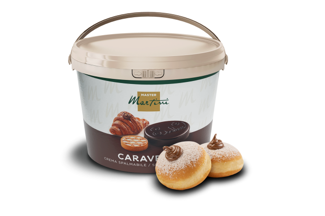 A large tub of Master Martini Caravella chocolate spreadable cream beside two powdered-sugar donuts filled with choco...