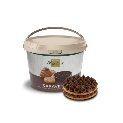 A bucket of Master Martini Caravella chocolate spreadable cream beside a pastry topped with piped chocolate swirls.