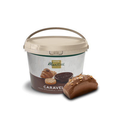 A tub of Master Martini Caravella hazelnut spreadable cream beside a chocolate-glazed pastry topped with chopped nuts.