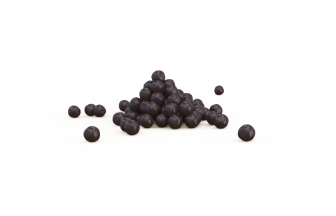 Small pile of dark purple round pellets on a white background, with a few scattered separately.