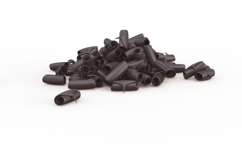 A pile of small black plastic tube-shaped caps scattered on a plain white background.