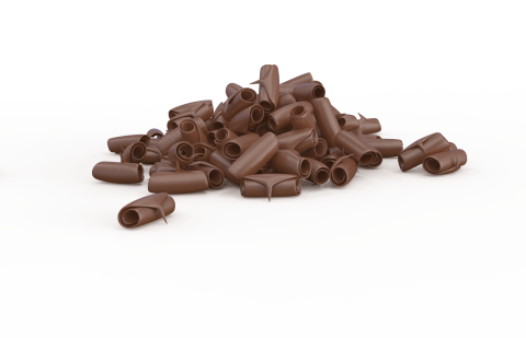 A pile of curled chocolate shavings scattered on a plain white background.