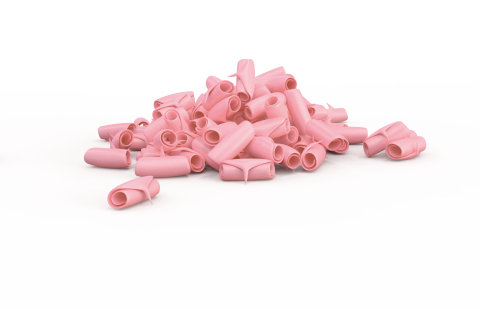 Pile of pink, tube-shaped chewing gum pieces scattered on a white background.