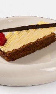 Slice of chocolate cake with cream, raspberry, and chocolate stick on glossy white plate.